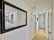 Hallway featuring wood floors, a decorative mirror, and access to other rooms at 8873 Princeton St, Westminster, CO 80031
