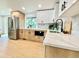 Modern kitchen with stainless steel appliances, light wood cabinets, and a large island at 8873 Princeton St, Westminster, CO 80031