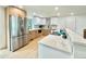Modern kitchen featuring stainless steel appliances, a large island, and white and wood cabinets at 8873 Princeton St, Westminster, CO 80031