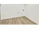Empty laundry room with wood flooring and white walls, ready for appliances and storage at 8873 Princeton St, Westminster, CO 80031
