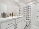 Elegant bathroom featuring double sink vanity, a bathtub with shower and tile floors at 5148 Taft Ct, Wheat Ridge, CO 80033