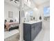Modern bathroom with double sinks, grey cabinetry and a view into the bedroom at 5148 Taft Ct, Wheat Ridge, CO 80033