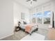 Bright bedroom featuring a large window, plush carpet, and a comfortable bed with stylish decor at 5148 Taft Ct, Wheat Ridge, CO 80033