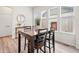 Inviting dining area with wood table and chairs, complemented by natural light from surrounding windows at 5148 Taft Ct, Wheat Ridge, CO 80033