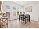 Bright dining area with wood flooring, a modern table set, and views to the outside at 5148 Taft Ct, Wheat Ridge, CO 80033