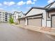 New townhome garages, with neutral siding, dark trim, and well maintained landscaping at 5148 Taft Ct, Wheat Ridge, CO 80033