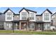 Modern townhomes featuring stone accents, neutral colors, and large windows for ample natural light at 5148 Taft Ct, Wheat Ridge, CO 80033