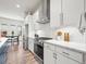 Modern kitchen with white cabinetry, stainless steel appliances, and a stylish backsplash at 5148 Taft Ct, Wheat Ridge, CO 80033