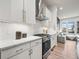 Modern kitchen featuring white cabinets, stainless steel appliances, and a stylish herringbone backsplash at 5148 Taft Ct, Wheat Ridge, CO 80033