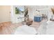 Open floor plan with living room, dining area, and kitchen connected with modern finishes and lots of light at 5148 Taft Ct, Wheat Ridge, CO 80033