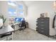 Bright office featuring large windows, vaulted ceilings, desk with computer setup, and storage at 5148 Taft Ct, Wheat Ridge, CO 80033