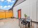 Cozy outdoor patio features a black dining set, privacy fence, and modern concrete design at 5148 Taft Ct, Wheat Ridge, CO 80033