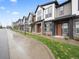 Attractive townhomes with neutral paint, stone accents, and manicured landscaping line a city street at 5148 Taft Ct, Wheat Ridge, CO 80033