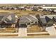 Aerial view of a single-Gathering home, featuring a modern roof, 3-car garage, and desert-style landscaping at 2794 Heron Lakes Pkwy, Berthoud, CO 80513