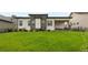 Spacious backyard with well-maintained lawn, modern architecture, and outdoor living space at 2794 Heron Lakes Pkwy, Berthoud, CO 80513