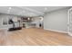 Large basement with hardwood floors, a treadmill, and a kitchenette with a peninsula at 2794 Heron Lakes Pkwy, Berthoud, CO 80513