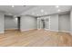 Spacious basement with hardwood floors, recessed lighting, and a pair of glass panel doors at 2794 Heron Lakes Pkwy, Berthoud, CO 80513