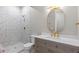 Modern bathroom featuring detailed tile in the shower, vanity with stone countertop, and gold hardware at 2794 Heron Lakes Pkwy, Berthoud, CO 80513