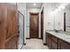 Bathroom with double vanity, granite countertop, tile flooring, and glass shower at 2794 Heron Lakes Pkwy, Berthoud, CO 80513
