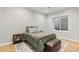 Cozy bedroom with wood floors, comfortable bedding, and a window at 2794 Heron Lakes Pkwy, Berthoud, CO 80513