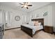 Comfortable bedroom featuring a ceiling fan, multiple windows, and wood trim at 2794 Heron Lakes Pkwy, Berthoud, CO 80513