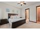 Bright primary bedroom with ceiling fan, ensuite bathroom, and wood trim at 2794 Heron Lakes Pkwy, Berthoud, CO 80513
