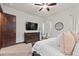 Bedroom with mounted television, dresser, window, and ensuite bath access at 2794 Heron Lakes Pkwy, Berthoud, CO 80513