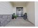 Charming covered front porch with decorative door and stylish decor at 2794 Heron Lakes Pkwy, Berthoud, CO 80513