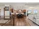 Open kitchen with stainless steel appliances, a large island, and hardwood floors, seamlessly flowing into the living area at 2794 Heron Lakes Pkwy, Berthoud, CO 80513