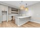 Basement kitchenette featuring neutral cabinets, white countertops, and wicker pendant lights at 2794 Heron Lakes Pkwy, Berthoud, CO 80513
