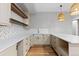 Basement kitchenette featuring light neutral cabinets, white countertop, and a wicker pendant light at 2794 Heron Lakes Pkwy, Berthoud, CO 80513