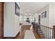 Open-concept living area with fireplace, hardwood floors, and staircase at 2794 Heron Lakes Pkwy, Berthoud, CO 80513