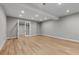 Spacious living room featuring wood floors, recessed lighting and glass paneled doors at 2794 Heron Lakes Pkwy, Berthoud, CO 80513