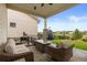 Outdoor patio area with comfortable seating, a fire pit, and a view of the landscaped backyard at 2794 Heron Lakes Pkwy, Berthoud, CO 80513