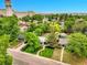 Aerial view of a charming home with lush landscaping in a quiet, tree-lined neighborhood at 5152 Bryant St, Denver, CO 80221