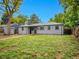 Large fenced back yard features new grass, mature trees, and a detached garage at 5152 Bryant St, Denver, CO 80221
