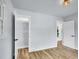 Bright bedroom features hardwood floors, an open closet, a modern light fixture, and white trim at 5152 Bryant St, Denver, CO 80221