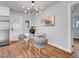 Dining area with a glass table and modern chandelier at 5152 Bryant St, Denver, CO 80221