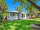 Charming single-story home featuring mature trees, manicured lawn, and tasteful landscaping at 5152 Bryant St, Denver, CO 80221