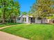 Charming single-story home features a well-maintained lawn, sidewalk, and mature shade trees at 5152 Bryant St, Denver, CO 80221