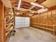 Garage interior with exposed wood framing, shelving, and overhead lighting at 5152 Bryant St, Denver, CO 80221