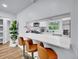 Bright kitchen featuring a breakfast bar with seating, stainless steel appliances, and a window view at 5152 Bryant St, Denver, CO 80221