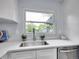 Bright kitchen featuring a stainless steel sink, quartz countertops, and a window view at 5152 Bryant St, Denver, CO 80221