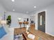 Open-concept living room with wood floors, modern decor, and a view into the kitchen at 5152 Bryant St, Denver, CO 80221