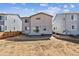 New construction home featuring a backyard with sliding glass doors and concrete patio pad at 1397 Brookfield Pl, Erie, CO 80026