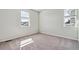 Bright bedroom with natural light streaming in from two windows at 1397 Brookfield Pl, Erie, CO 80026