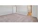 Spacious bedroom featuring neutral walls and plush carpeting leading to a walk-in closet at 1397 Brookfield Pl, Erie, CO 80026