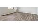 Neutral bedroom features hardwood-style flooring, white walls, base trim, and natural light from the exterior windows at 1397 Brookfield Pl, Erie, CO 80026