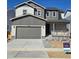 Charming two-story home featuring a covered porch, attached two-car garage and newly landscaped front yard at 1397 Brookfield Pl, Erie, CO 80026