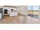 Modern kitchen with stainless steel appliances, white cabinetry, and sliding glass door at 1397 Brookfield Pl, Erie, CO 80026
